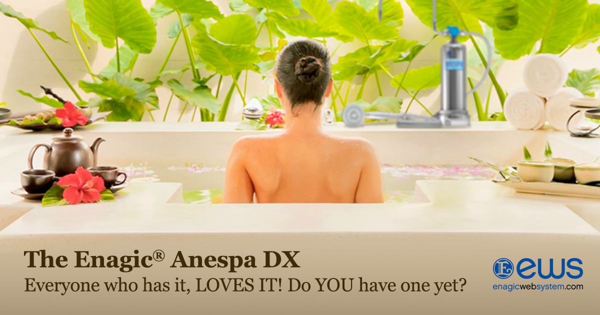 A woman seen from behind sitting in a white bathtub with tropical green leaves and flowers around her. The Enagic Anespa DX promotional text appears at the bottom with the Enagic logo in the corner.